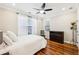 Cozy bedroom featuring hardwood floors, a queen bed, and a ceiling fan at 1429 Ferocity Ridge Nw Way # 12, Kennesaw, GA 30152