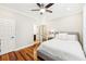 Bright bedroom with hardwood floors and a comfortable queen-sized bed and ceiling fan at 1429 Ferocity Ridge Nw Way # 12, Kennesaw, GA 30152