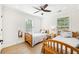 Bright bedroom featuring hardwood floors, two twin beds, and a ceiling fan at 1429 Ferocity Ridge Nw Way # 12, Kennesaw, GA 30152