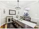 This dining room offers a view into the kitchen area, with a chandelier and an attractive sideboard at 1429 Ferocity Ridge Nw Way # 12, Kennesaw, GA 30152