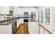 Charming kitchen features stainless appliances, granite countertops, white cabinets, and access to the backyard at 1429 Ferocity Ridge Nw Way # 12, Kennesaw, GA 30152