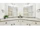 Elegant bathroom with dual sinks, granite counters, sleek cabinetry, and decorative mirrors at 1429 Ferocity Ridge Nw Way # 12, Kennesaw, GA 30152