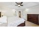 Bright main bedroom features a tray ceiling, light-colored walls, wood floors, and ensuite bathroom and closet at 1429 Ferocity Ridge Nw Way # 12, Kennesaw, GA 30152