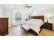 Spacious main bedroom with tray ceiling, wood floors, a large window, and decorative bedside tables at 1429 Ferocity Ridge Nw Way # 12, Kennesaw, GA 30152