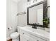 Charming powder room with decorative mirror, modern vanity, faucet, and stylish lighting at 1429 Ferocity Ridge Nw Way # 12, Kennesaw, GA 30152