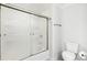 Clean shower with glass doors, modern fixtures, and a convenient toilet at 1429 Ferocity Ridge Nw Way # 12, Kennesaw, GA 30152