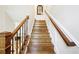 Beautiful staircase with oak treads, decorative iron spindles, and wood railing at 1429 Ferocity Ridge Nw Way # 12, Kennesaw, GA 30152