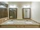 Bathroom with double sinks, granite countertops, decorative mirrors, and tiled floors at 3155 Boldmere Se Trl # 3, Smyrna, GA 30080