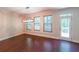 Dining room featuring hardwood floors, modern chandelier lighting, and a door leading to the backyard deck at 3155 Boldmere Se Trl # 3, Smyrna, GA 30080