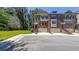 Charming brick townhomes feature attached garages, a neatly kept green space, and convenient parking at 3155 Boldmere Se Trl # 3, Smyrna, GA 30080
