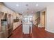 Spacious kitchen featuring hardwood floors, stainless appliances, and a granite island at 3155 Boldmere Se Trl # 3, Smyrna, GA 30080