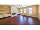 Open living room with hardwood floors, a fireplace, built-ins, and natural light at 3155 Boldmere Se Trl # 3, Smyrna, GA 30080