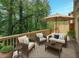 Outdoor patio with comfortable seating, an umbrella, and a view of the surrounding greenery at 3155 Boldmere Se Trl # 3, Smyrna, GA 30080