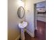 Bathroom with pedestal sink, decorative mirror, and view to the kitchen at 3155 Boldmere Se Trl # 3, Smyrna, GA 30080