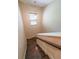 Stairway with stained wood steps, white risers, dark railing, and pendant lighting at 3155 Boldmere Se Trl # 3, Smyrna, GA 30080