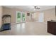 Spacious finished basement with tile flooring, a ceiling fan, and access to the backyard at 100 Coldwater Creek Dr, Mcdonough, GA 30252