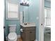 Half bathroom with a blue color scheme, sink, toilet, and natural lighting at 100 Coldwater Creek Dr, Mcdonough, GA 30252