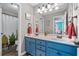 Updated bathroom with double sinks, blue cabinetry, and a decorative shower curtain at 100 Coldwater Creek Dr, Mcdonough, GA 30252