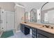 Modern bathroom with dual vanities, stylish mirrors, and a walk-in shower at 100 Coldwater Creek Dr, Mcdonough, GA 30252