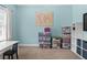 Bedroom featuring light blue walls, carpeted flooring, and a wall decoration at 100 Coldwater Creek Dr, Mcdonough, GA 30252