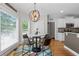 Sunlit breakfast nook with round table, modern lighting, and hardwood flooring at 100 Coldwater Creek Dr, Mcdonough, GA 30252