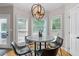 Cozy breakfast nook with lots of natural light and modern pendant lighting at 100 Coldwater Creek Dr, Mcdonough, GA 30252
