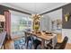 Bright dining room featuring modern chandelier, large windows, and stylish decor, perfect for gatherings at 100 Coldwater Creek Dr, Mcdonough, GA 30252