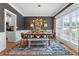 Elegant dining room with modern chandelier, stylish decor, large window, and hardwood floors at 100 Coldwater Creek Dr, Mcdonough, GA 30252