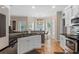 Bright kitchen featuring stainless appliances, granite counters, island with bar, and hardwood floors at 100 Coldwater Creek Dr, Mcdonough, GA 30252