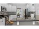 Open kitchen featuring stainless steel appliances, white cabinets, granite countertops, and a view into the dining area at 100 Coldwater Creek Dr, Mcdonough, GA 30252