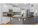 Well-lit kitchen with stainless steel appliances, white cabinetry, granite counters, and a gray tile backsplash at 100 Coldwater Creek Dr, Mcdonough, GA 30252