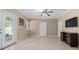 Living room featuring tile flooring, neutral colored walls, ceiling fan, and direct backyard access at 100 Coldwater Creek Dr, Mcdonough, GA 30252