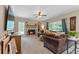 Bright living room with fireplace, plush sectional, and large windows offering a comfortable and inviting space at 100 Coldwater Creek Dr, Mcdonough, GA 30252
