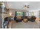 Spacious living room with a cozy fireplace, large sectional sofa, and ample natural light creating a comfortable atmosphere at 100 Coldwater Creek Dr, Mcdonough, GA 30252