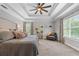 Spacious main bedroom featuring a tray ceiling, plush carpeting, and large windows with natural light at 100 Coldwater Creek Dr, Mcdonough, GA 30252