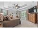 Spacious main bedroom featuring a tray ceiling, plush carpeting, and large windows with natural light at 100 Coldwater Creek Dr, Mcdonough, GA 30252