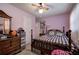 Traditional bedroom with a black and white checkered bedspread and a ceiling fan at 1001 Rhett Nw Dr, Kennesaw, GA 30144