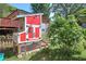 View of a backyard chicken coop, featuring red and white trim with secured fencing at 1001 Rhett Nw Dr, Kennesaw, GA 30144