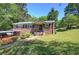 Charming brick home with a well-maintained lawn, mature trees, and inviting front porch at 1001 Rhett Nw Dr, Kennesaw, GA 30144