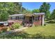 Charming brick home with a well-maintained lawn, mature trees, and inviting front porch at 1001 Rhett Nw Dr, Kennesaw, GA 30144