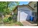 Exterior shot of a single-car garage with white door and a blue trash can at 1001 Rhett Nw Dr, Kennesaw, GA 30144