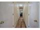 Long hallway with neutral walls and wood-look flooring leads to various rooms at 1001 Rhett Nw Dr, Kennesaw, GA 30144