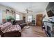 Cozy living room with hardwood floors, a decorative fireplace, and ample natural light at 1001 Rhett Nw Dr, Kennesaw, GA 30144