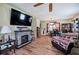 Cozy living room with hardwood floors, a decorative fireplace, and ample natural light at 1001 Rhett Nw Dr, Kennesaw, GA 30144