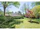 View of a well-maintained backyard with lush green grass and mature trees at 414 Pensdale Rd, Decatur, GA 30030