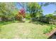 Spacious backyard featuring a vibrant Japanese maple tree and lush green lawn at 414 Pensdale Rd, Decatur, GA 30030