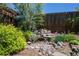 Backyard waterfall feature surrounded by rocks and lush greenery at 414 Pensdale Rd, Decatur, GA 30030