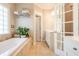 A spacious bathroom featuring a tub with tile surround, and a double vanity at 414 Pensdale Rd, Decatur, GA 30030