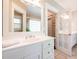 Bathroom featuring a white vanity, sink, mirror and decorative french doors at 414 Pensdale Rd, Decatur, GA 30030
