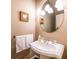 Elegant bathroom with a pedestal sink, ornate mirror, and stylish lighting fixtures at 414 Pensdale Rd, Decatur, GA 30030